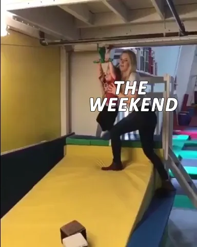 Woman holding child on monkey bars, text 'THE WEEKEND', both falling/swinging, gym setting, weekend fail