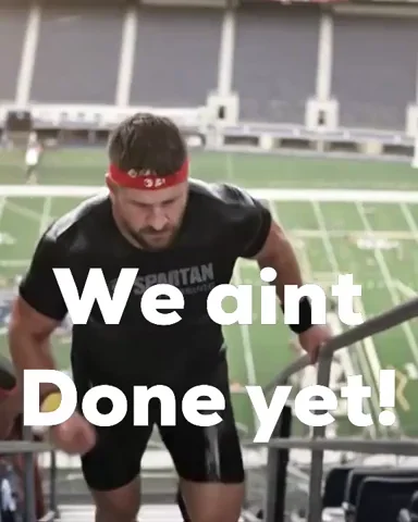 Muscled athlete saying 'We ain't done yet' — perseverance despite difficulty.