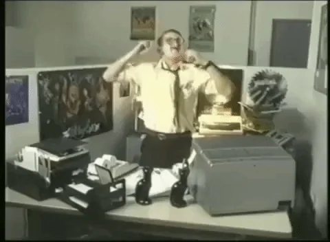 Office worker in uniform dancing and celebrating at his desk, energetic victory dance, papers flying