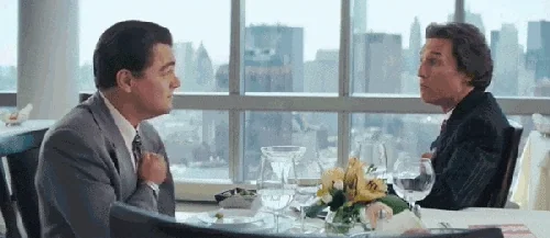Leonardo DiCaprio and Matthew McConaughey having lunch at a fancy restaurant with Manhattan skyline, Wolf of Wall Street mentorship/discussion scene