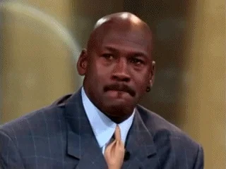 Michael Jordan in suit tearing up, the iconic Crying Jordan meme, emotional/sad expression during interview