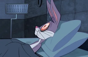 Bugs Bunny in bed with wide-open eyes at night, unable to sleep