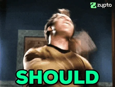 Captain Kirk (Star Trek) being shaken/shocked, text 'SHOULD' in green, Zypto watermark, dramatic reaction