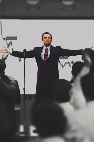 Leonardo DiCaprio as Jordan Belfort (Wolf of Wall Street), arms wide open in triumph in front of a crowd, candlestick chart displayed behind him