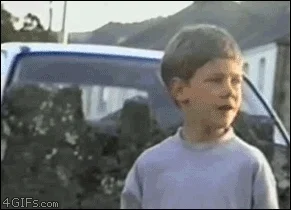 Young boy with shocked/amazed expression, mouth open, looking at something off-screen, classic kid reaction, 4GIFs watermark