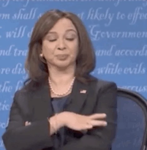 Kamala Harris geste stop/ralentis — stop, attendez, pause