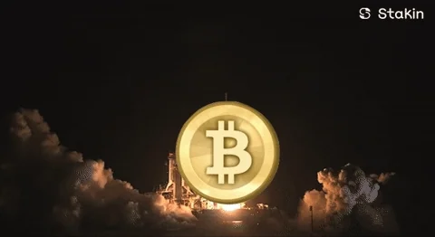 Bitcoin coin launching like a rocket with smoke and flames, real rocket launch footage with BTC overlay, Stakin watermark, to the moon vibes