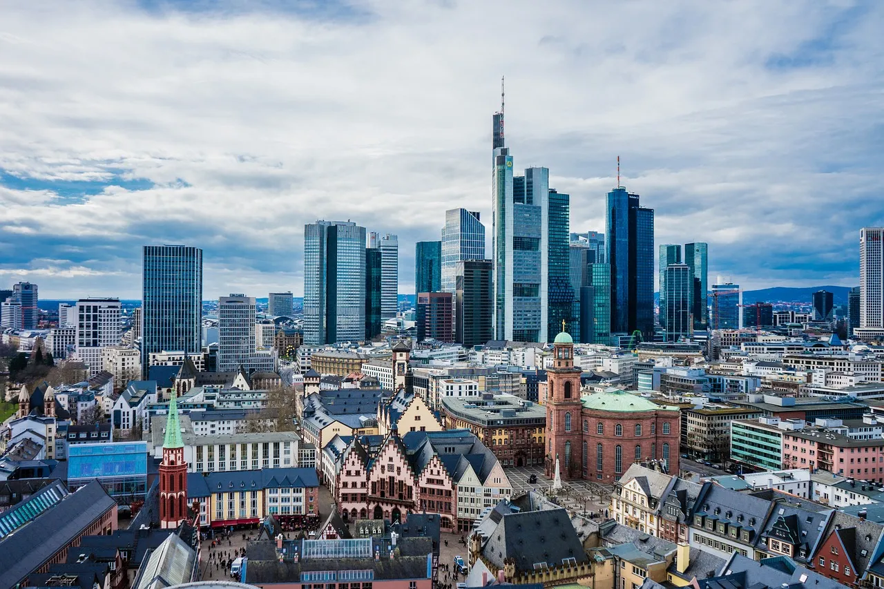 An aerial view of Frankfurt's skyline, blending historic architecture with modern skyscrapers.