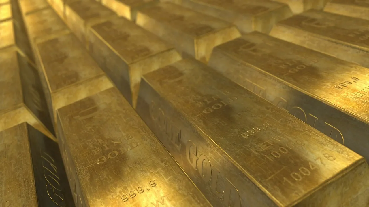 A close-up, high-angle shot of numerous gold bars stacked in rows.