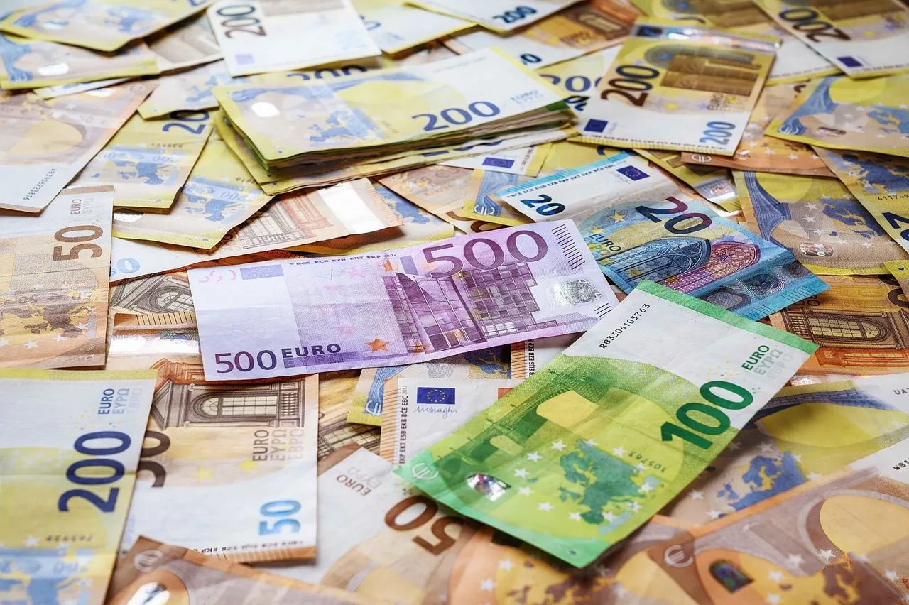 A scattered pile of various Euro banknotes, including 500, 200, 100, 50, and 20 Euro denominations.